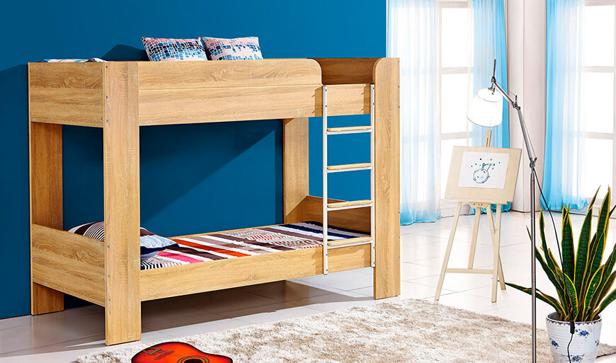 Light brown bunkbed with top and bottom beds linked with a ladder in a kids room with blue painted walls